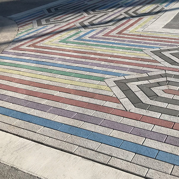 Different color pavers are placed to create a pattern.