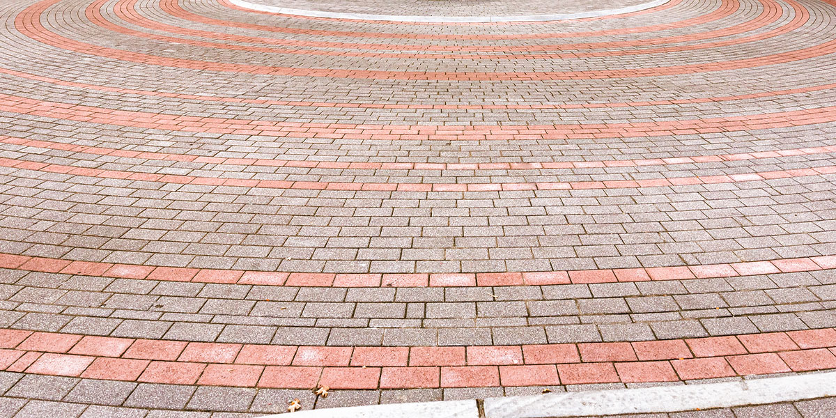 Red and gray pavers in a circular formation.