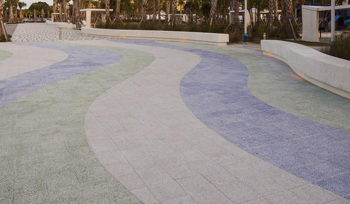 This curved paver pattern features blue, green and white pavers.